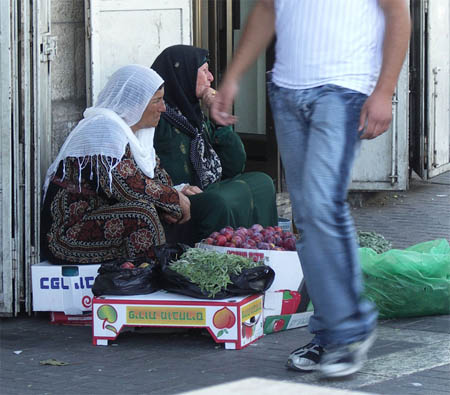 Women selling sage and plums